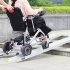 Persona en silla de ruedas subiendo por la rampa TRAN-MR